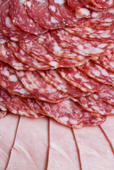Cutting sausage and cured meat on a celebratory table