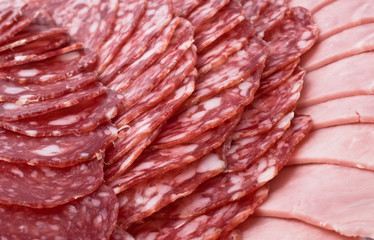 Cutting sausage and cured meat on a celebratory table