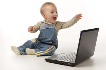 The small smiling happy kid with the laptop