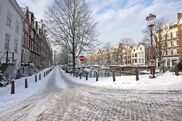 Poster Amsterdam covered with snow in the Netherlands © Nataraj