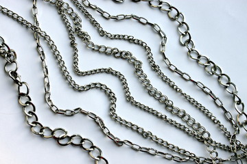 Various silver chains on a white background