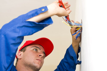 Handyman installing electricity in a new house