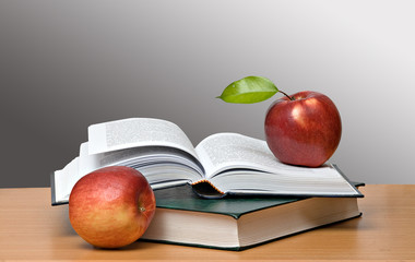 Red apples and open book