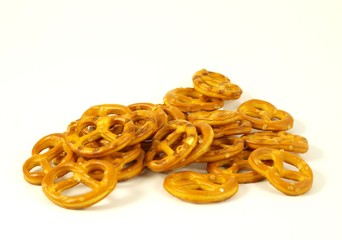 Golden salted pretzel on white background