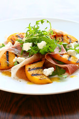salad with grilled peach and ham