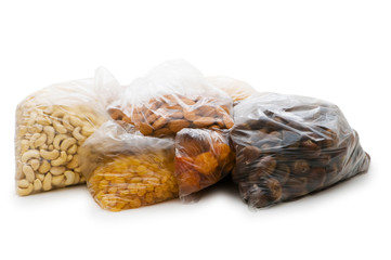 Various dry fruits in the bags on white