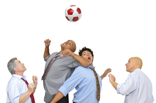 Businessmen playing soccer