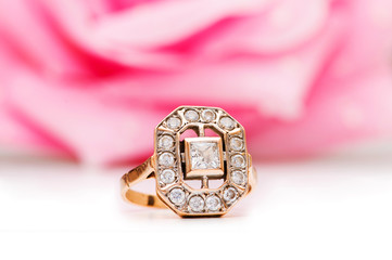 Golden ring and rose at the background