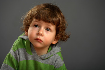 Naklejka premium Portrait of a nice little boy with a beautiful curly hair