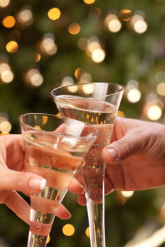 Man and Woman Toasting Champagne in Front of Lights