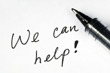 Fototapeta premium The words We Can Help on a white paper