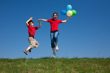 Kids holding balloons ,playing outdoor