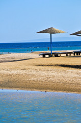 Straw umbrellas on the beach of Egypt
