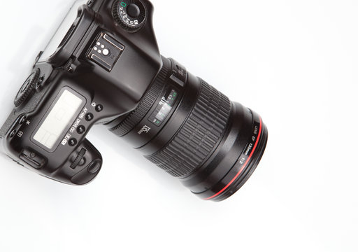 modern DSLR with a pro lens on white background