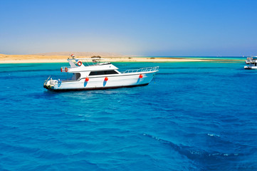 The white excursion yacht moored beside the island Giftun