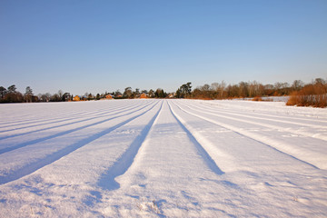 Fototapeta na wymiar Snow furrowed field in an English landscape