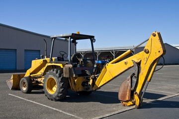 Yellow Earth Mover in Parking Lot