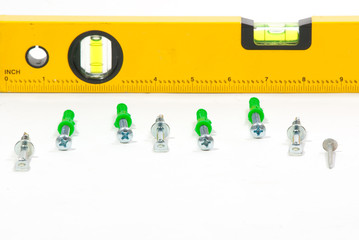 Level and screws isolated on white