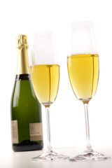 Champagne glasses with bottle on white