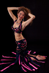 Belly dancer posing holding up her hair