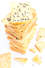Stack of crunchy bread  with sesame on top