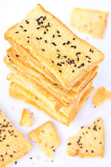 Stack of crunchy bread  with sesame on top
