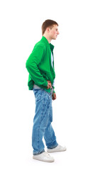 Young man standing with hands in pockets..