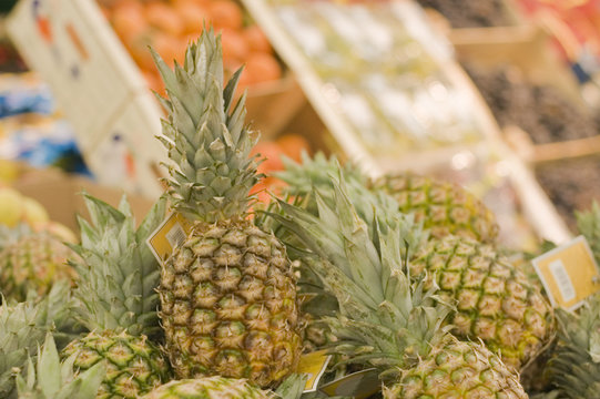 Shelf with pineapples in a supermarket