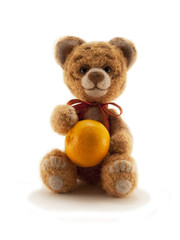 A toy knitted tiger with an orange