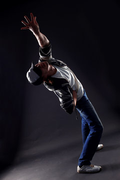 cool man modern dancer against black