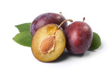 Plums and leaves on a white background.
