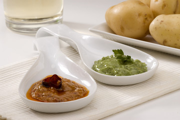 Spanish cuisine. Mojo verde and mojo picon. Green mojo and red m