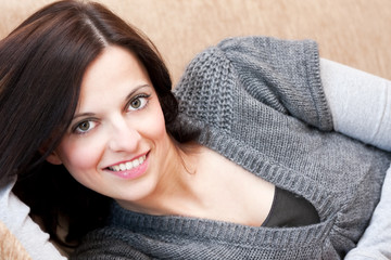 Beautiful brunette relaxing on the sofa