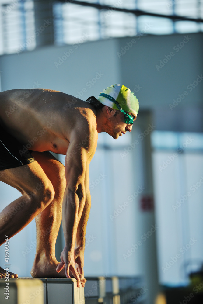 Wall mural young swimmmer on swimming start