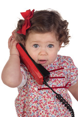 Funny baby girl with red telephone