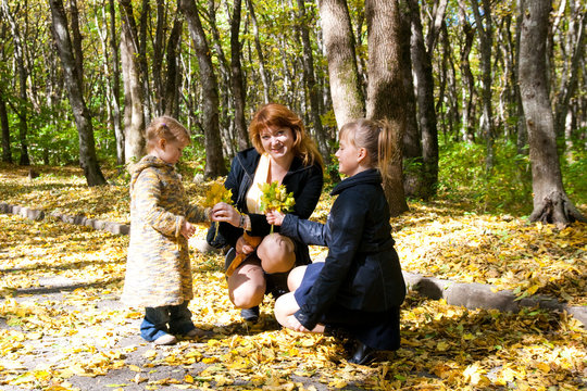 family in autumn leafs