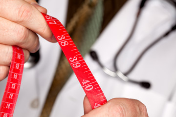 Doctor with Stethoscope Holding Measuring Tape