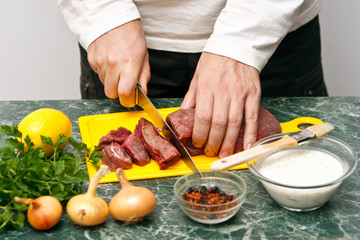 Man cutting raw fresh beef