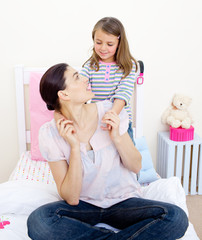 Adorable little girl cuddling her mother
