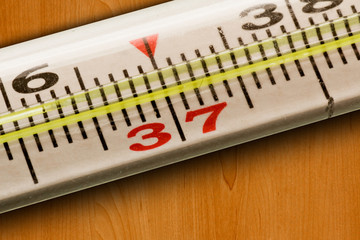 medical thermometer (37) on a wooden table