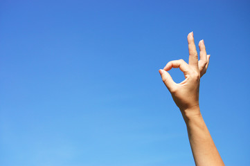 Ok sign against blue sky