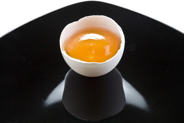 half white eggs on the black plate.