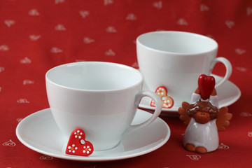 Empty cups with hearts and angel