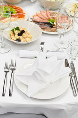 Table appointments for dinner in restaurant.