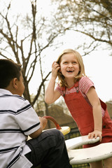 Young Girl and Boy Playing on Playground