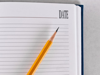 Opened notebook with a pencil