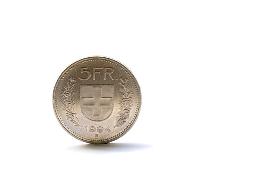 Single five Swiss franc coin isolated on white background
