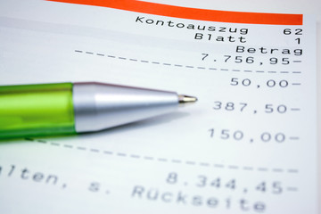 German bank statement with green ball pen
