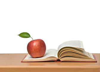 Red apple and book on desk