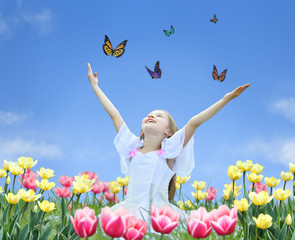 little girl in tulips with hands up and butterfly collage